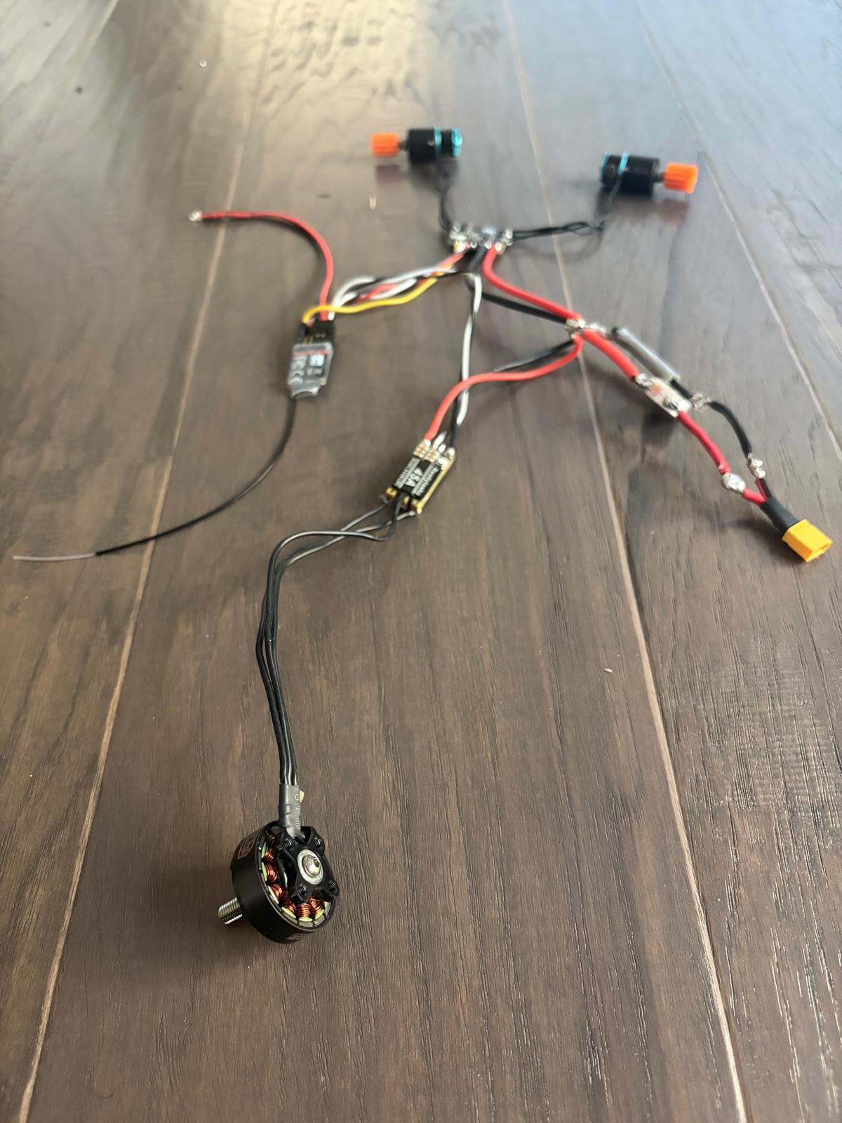 the harness on the floor with the 2305 weapon motor at the end